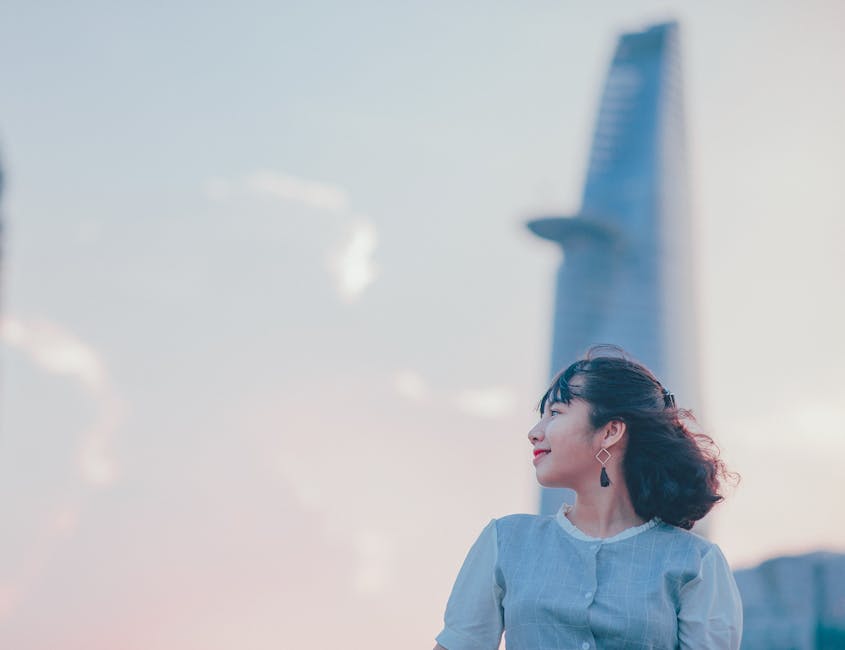 Woman looking toward a modern skyline